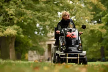 Person uses mobility scooter in nature