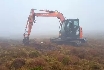 A digger working on an area of peatland