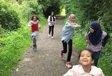 Children running outdoors whilst smiling