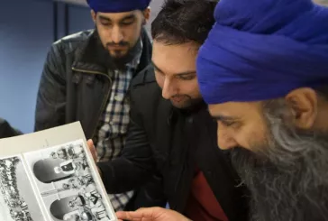 Sikh men looking at a book