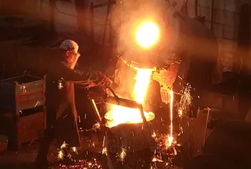 Person pouring hot liquid into a cast