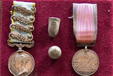 Close up of two bullets and two medals