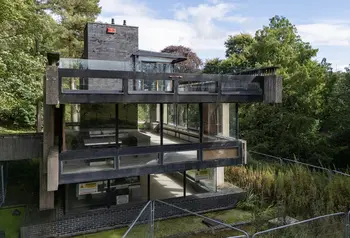 A view of the three levels of the Bernat Klein Studio, a brutalist concrete structure surrounded by woodland.