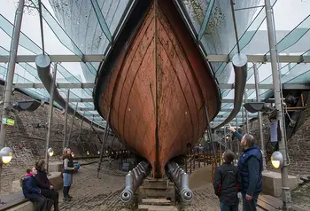 People look up at the hull of SS Great Britain from within the dry dock