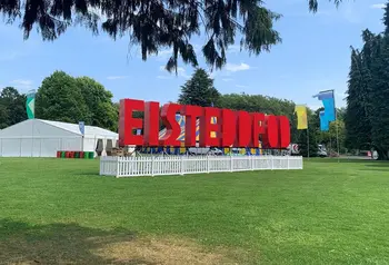 Large red letters spelling ‘Eisteddfod’ in front of tents in a field
