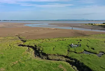 A group gathers on the landscape in the Solway Firth.