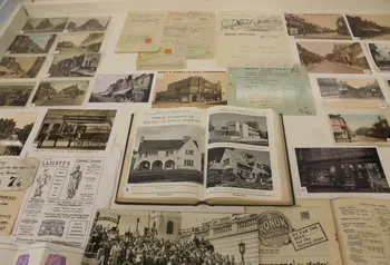 Heritage display for 'Woking's Story' exhibit, a collection of vintage postcards and books