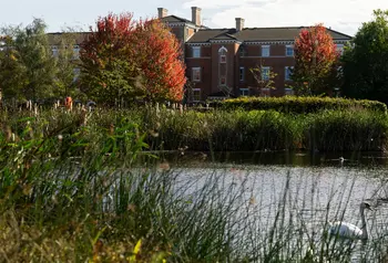 Forest Lane Park showing pond with wildlife, trees and historic building