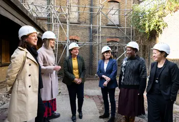 Group of people wearing hard hats in a courtyard of historic building, Alice Billings House in Stratford
