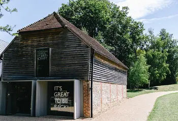 Exterior of Ditchling Museum with sign saying 'it's good to be back'.