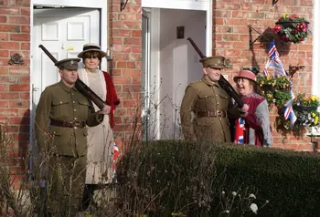 Two men dressed as soldiers standing at their front door