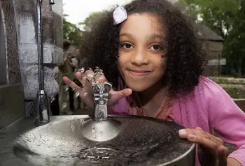 Girl using drinking fountain 