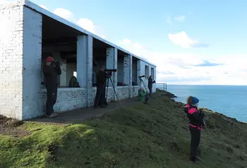People looking out to see through lenses, from hut 