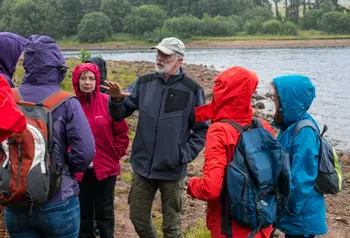 People in anoraks learning about Cairngorms