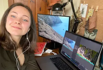 Person sitting in front of two computer screens
