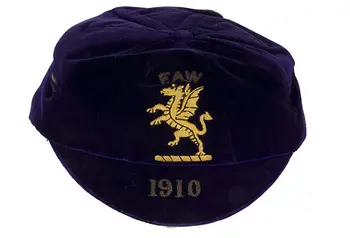 A cap embroidered with a Welsh dragon and the date 1910