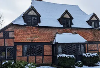A timber-framed building covered in snow