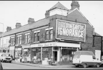 Old photo showing large billboard with the words "AIDS: don't die of ignorance"