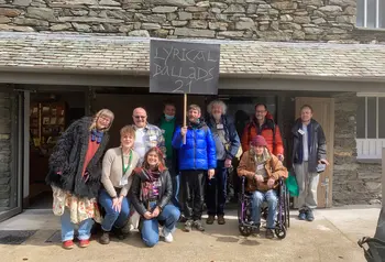 A group of people standing in front of Wordsworth Museum. One of them is holding a sign that reads 'Lyrical Ballads 21' 