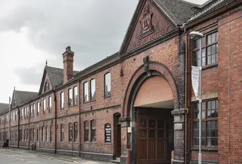 The outside front view of an old red brick building, Middleport pottery