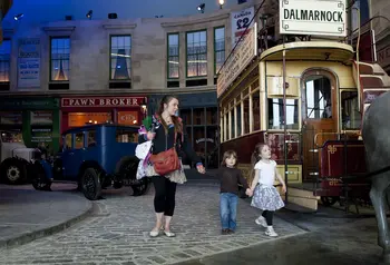 Adult and child walking through Glasgow Museums Resource Centre