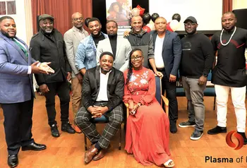 A group of black people pose for a photo including a woman