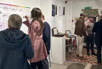 People look at an exhibition of LGBTQ+ people's stories