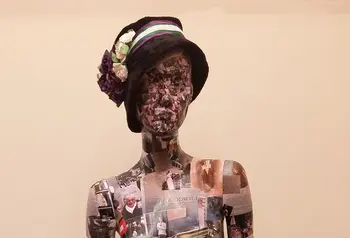 A mannequin covered in photos and documents. Volunteers created the 'Wo-Mannequin' from photos of the research, visits and materials they collected during the project