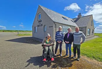 Four members of the Trust stand outside the Tomb of the Eagles visitor centre.