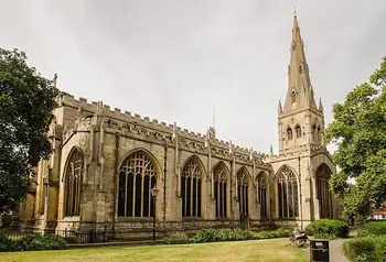 The exterior of a large church with a spire