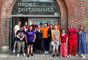 A group of people posing for the camera in front of the Aspex gallery in Portsmouth