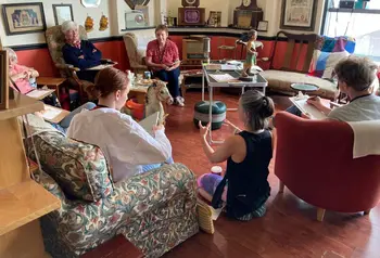 A group of different ages discuss nostalgic objects in the Wee Museum of Memory.