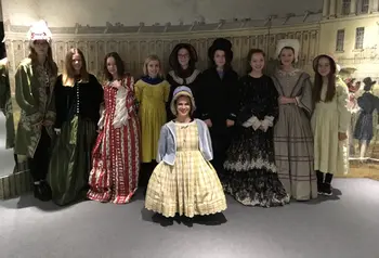 Young people trying on costumes at Bath Costume Museum