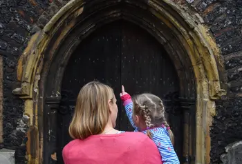 Mother and little girl look at St John Maddermarket Church, Norwich