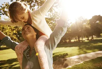 A mother and child have fun in a park