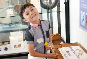 Child enjoying education activities of the Royal College of Music Museum 