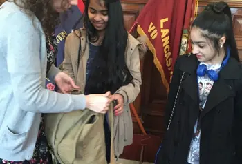 Young people look at army bag