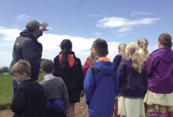 Children listening to a talk about the archaeological site