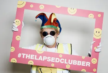 A lapsed clubber holding a picture frame, dressed in typical clubbing paraphernalia from the late 80s