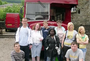 Young people in front of a vintage bus