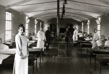 Participant as a VAD (Voluntary Aid Detachment) nurse in front of a green screen with an image of a First World War hospital