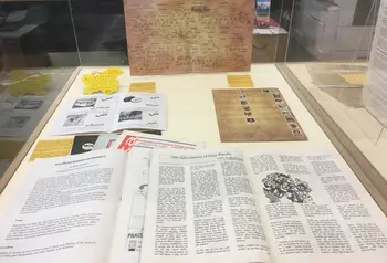 Booklets displayed in a glass display case at an exhibition
