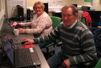 Man and a woman using computers
