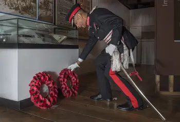 Veteran laying wreath of poppies at the celebration event