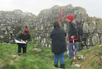 Participants measuring an archaeological sie
