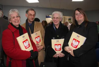 A group hold up books as part of the Poles in the Bristol Area project