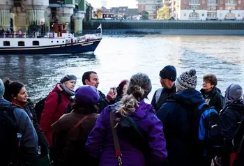 An expert explaining the historical significance of the docks, on site