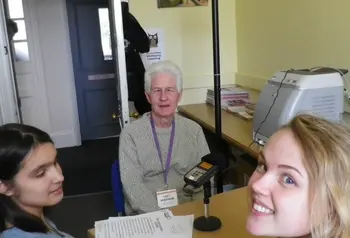 Two students interviewing an older person