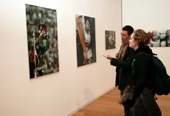 People look at pictures in Manchester Art Gallery 