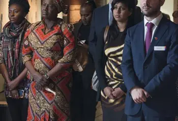 Delegates taking part in a moment of silence at launch event